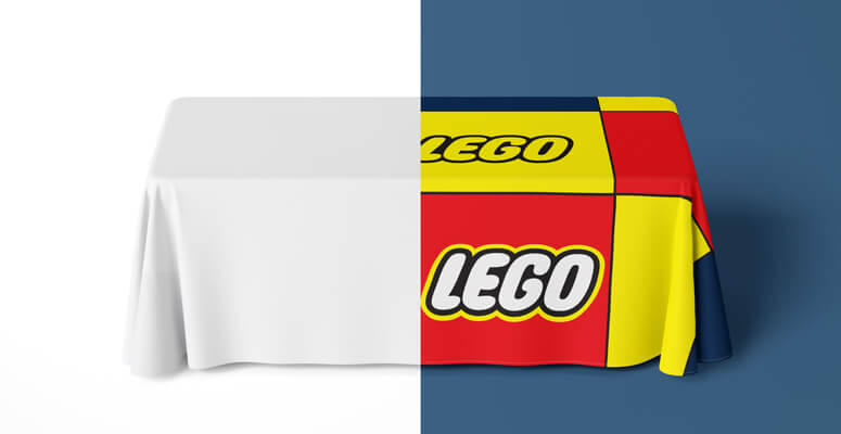 Table covered with Lego-branded table cover on half of the table, with the other half being plain white.