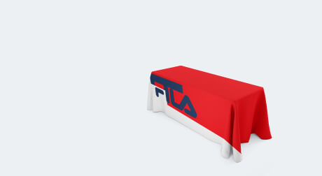 A table covered with table throw that has been customized with branding of Fila.